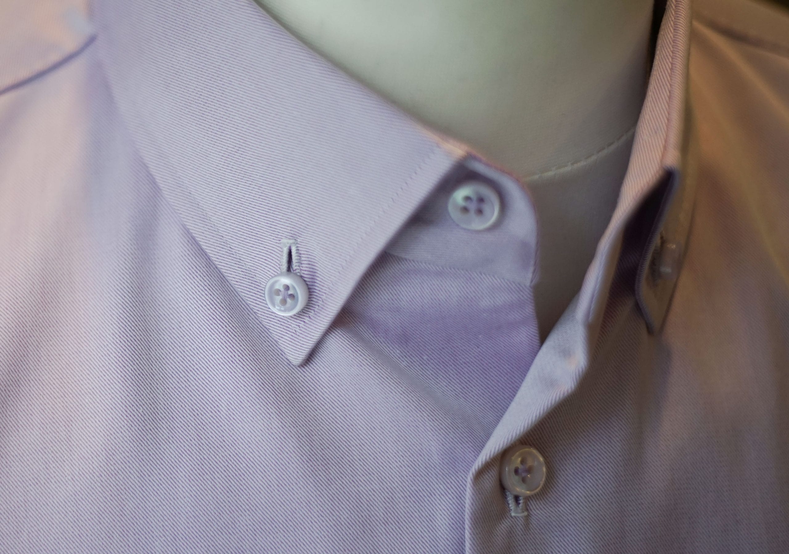 A red and white collar of a shirt on a mannequin